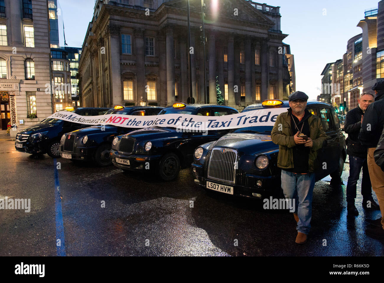 Black cabs seen blocking the bank junction during the protest. Dozens of black cab taxi drivers  together with their cabs protest against the ban of all vehicles (other than buses and bicycles) to access to Bank Junction between 7am and 7pm. With the ban The City of London Corporation's aims to improve pedestrian, cyclist safety and air quality. Stock Photo