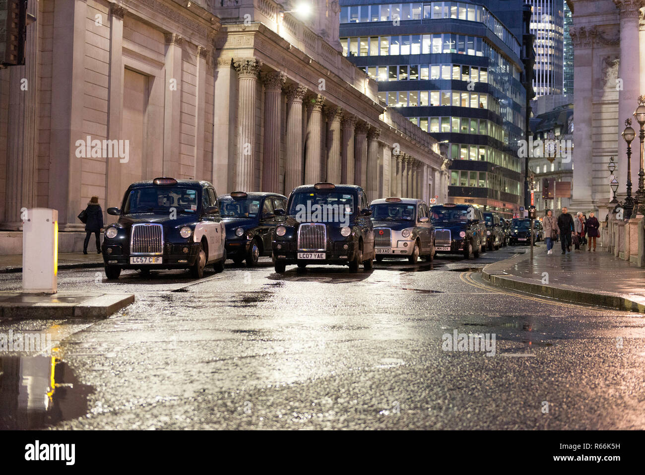 Black cabs seen blocking the bank junction during the protest. Dozens of black cab taxi drivers  together with their cabs protest against the ban of all vehicles (other than buses and bicycles) to access to Bank Junction between 7am and 7pm. With the ban The City of London Corporation's aims to improve pedestrian, cyclist safety and air quality. Stock Photo
