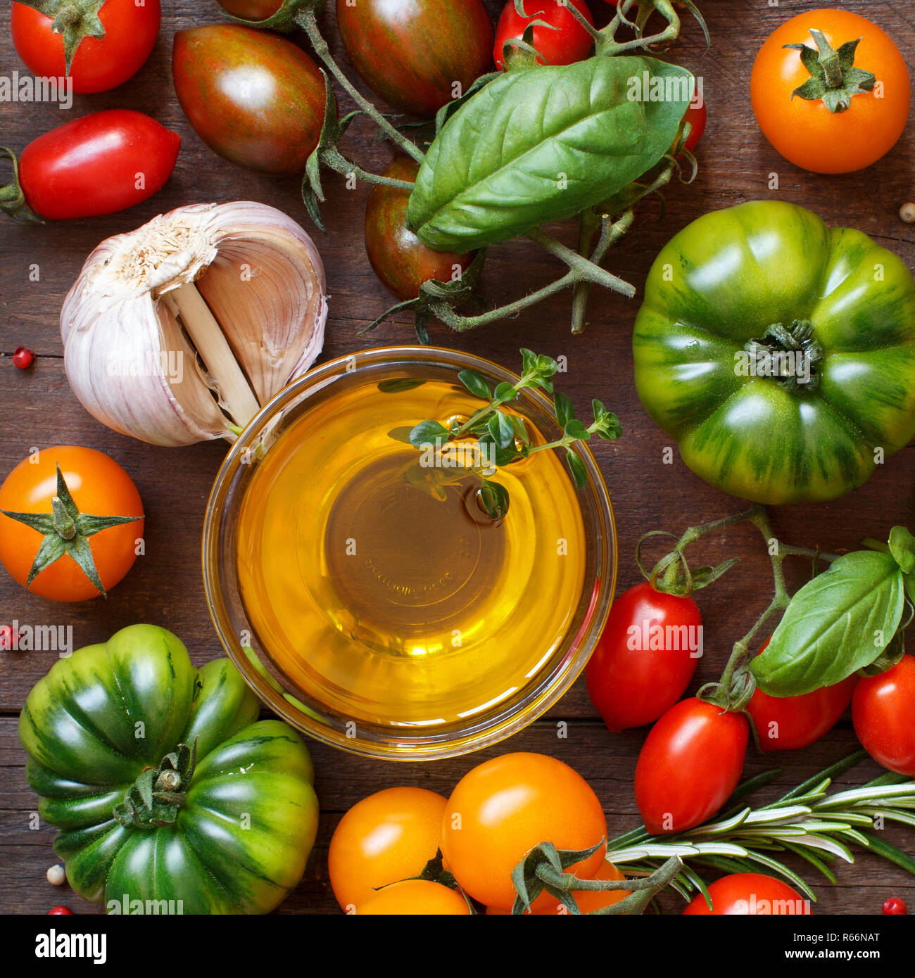 Colorful tomatoes, garlic, olive oil and herbs Stock Photo