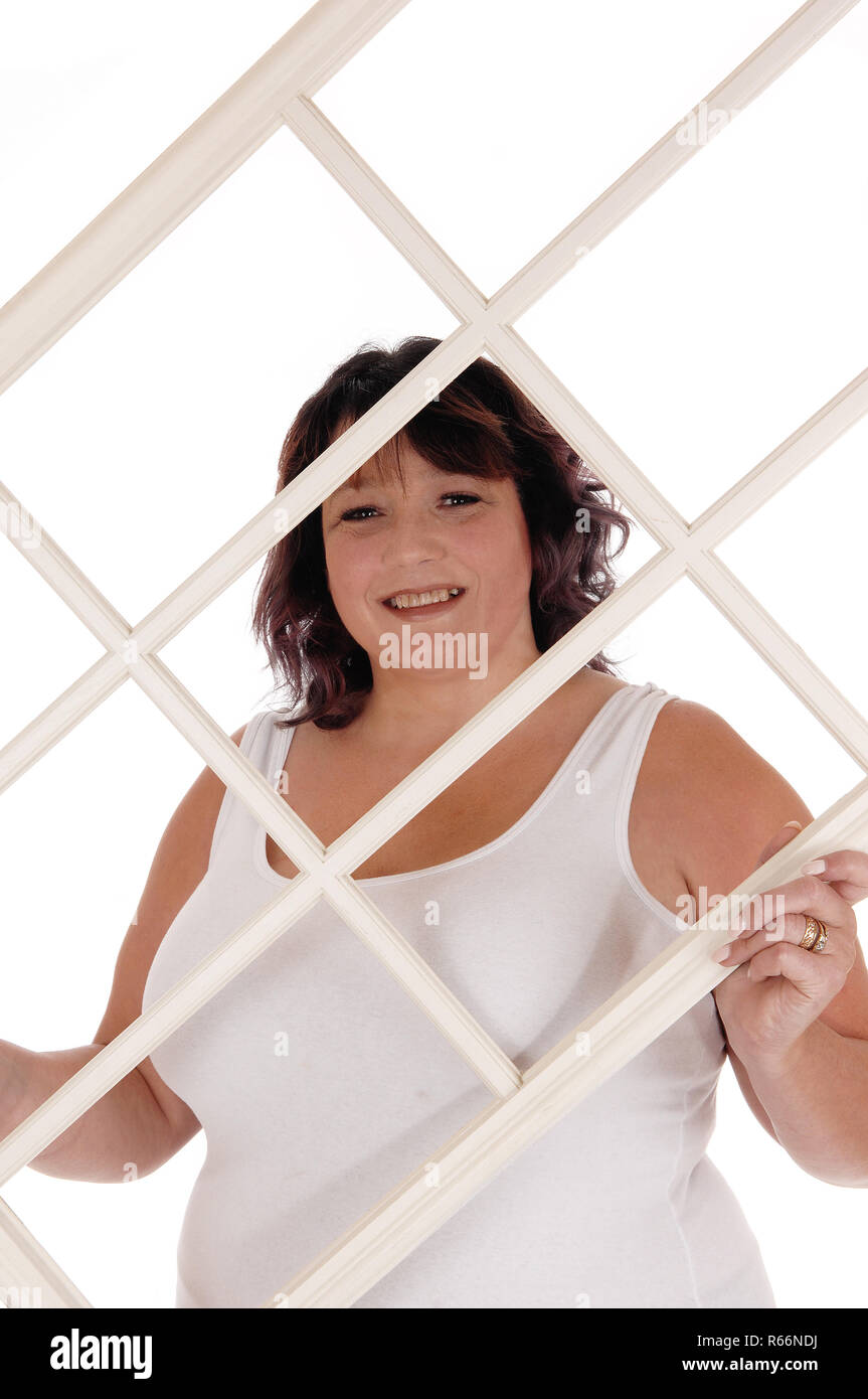 Big woman holding window frame Stock Photo