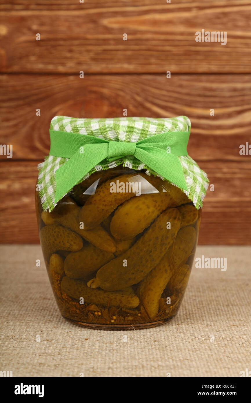 Jar of pickled small gherkin cucumbers on table Stock Photo Alamy
