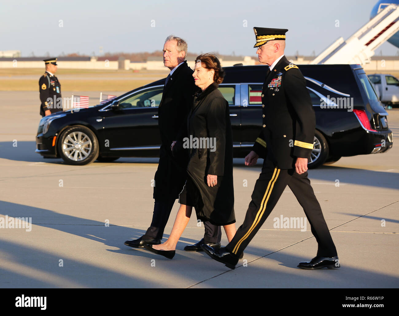 Former President, George W. Bush, with wife Laura Bush, depart from the airfield, Joint Base Andrews, Maryland, Dec. 03, 2018. Military and civilian personnel assigned to Joint Task Force- National Captial Region provided ceremonial and civil affairs support during President George H.W. Bush's state funeral. (DoD Photo by U.S. Army Pfc. Caeli Morris) Stock Photo