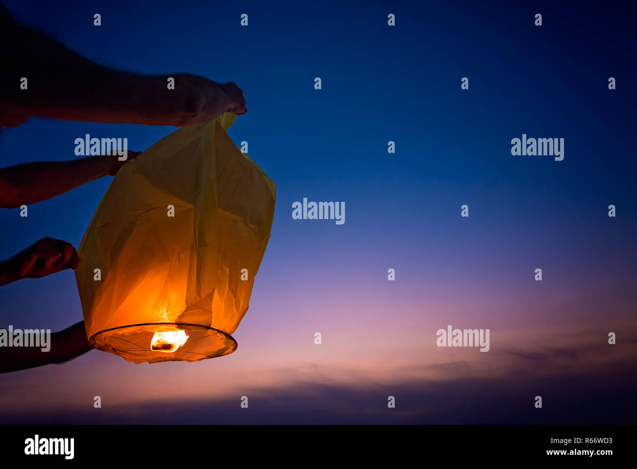 People setting off chinese lantern at sunset Stock Photo Alamy
