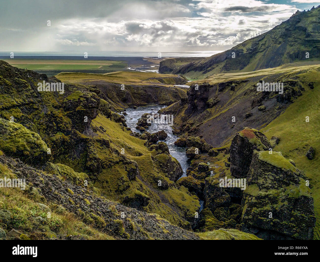 A Glaciel River runs through an Icelandic Landscape. Stock Photo