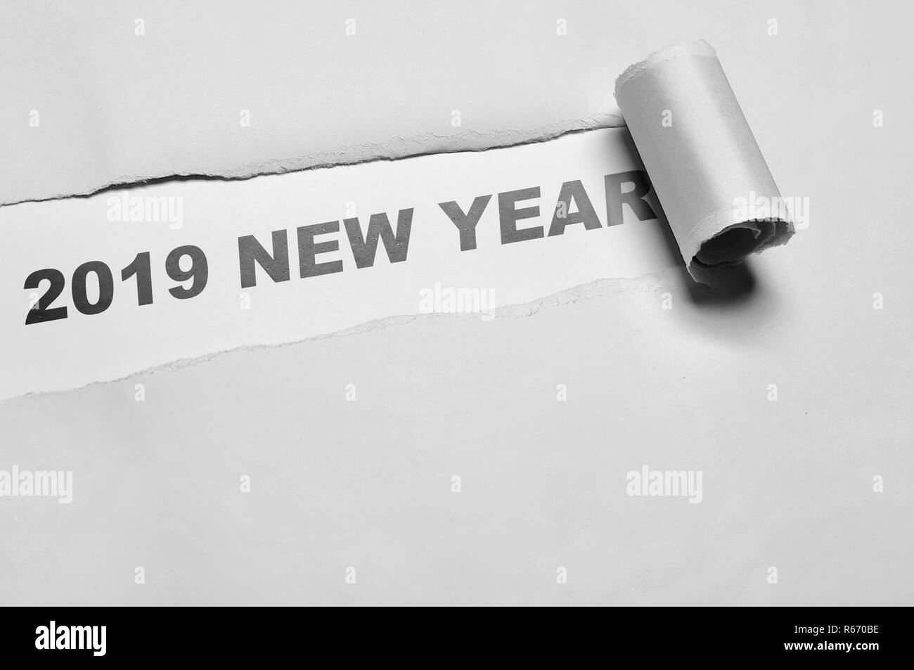 2019 New Year word written under gray torn paper. Happy New Year 2019 Stock Photo