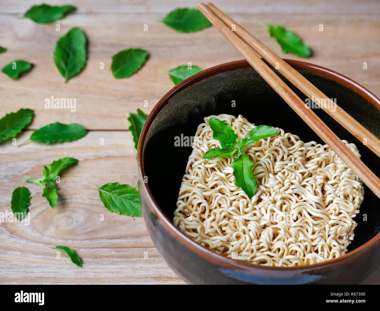 Instant noodles in black bowl. Stock Photo