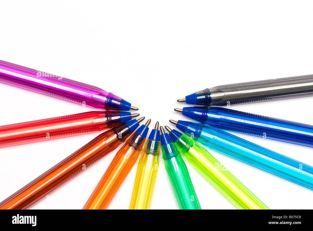 Colored plastic pens in arc on white background Stock Photo