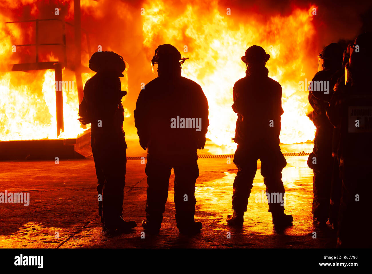 JOHANNESBURG, SOUTH AFRICA - OCTOBER, 2018 Firefighters spraying down fire during firefighting training exercise Stock Photo