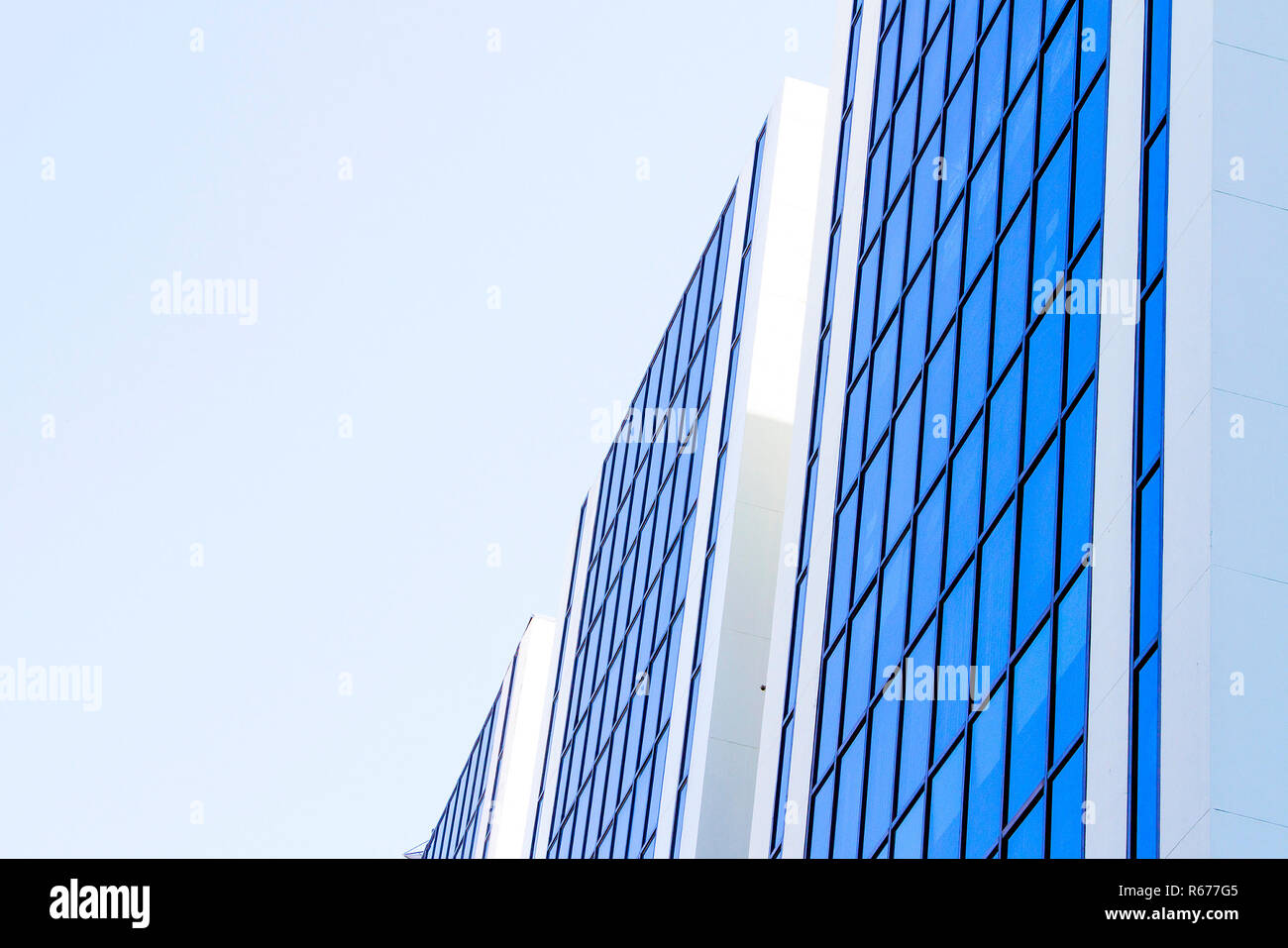 Blue sky reflected on blue building side Stock Photo - Alamy