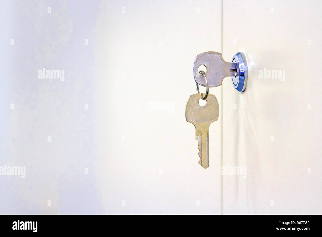 Two cabinet keys with white steel cabinet Stock Photo