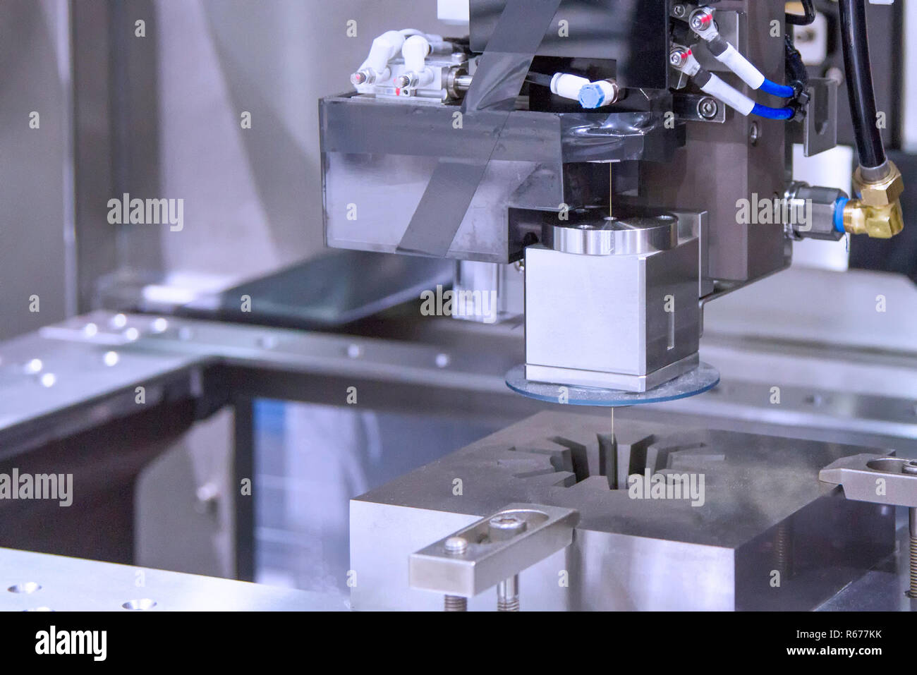 Wire cutting machine cutting metal Stock Photo Alamy