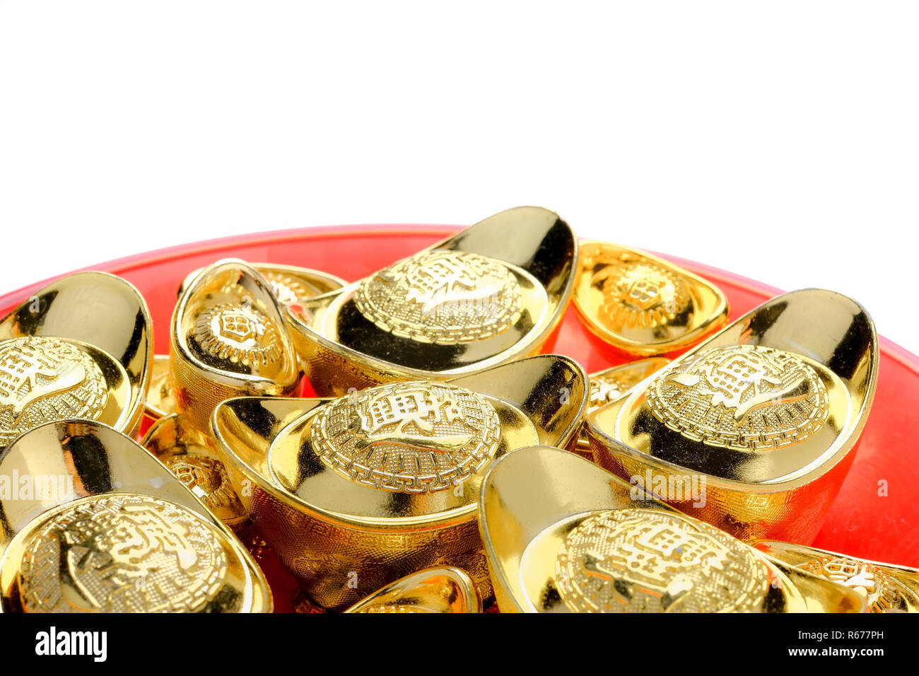 group of golden ingots on red tray isolate at white background.Chinese new year concept,leave space for adding text.Chinese Language on ingot mean 'We Stock Photo
