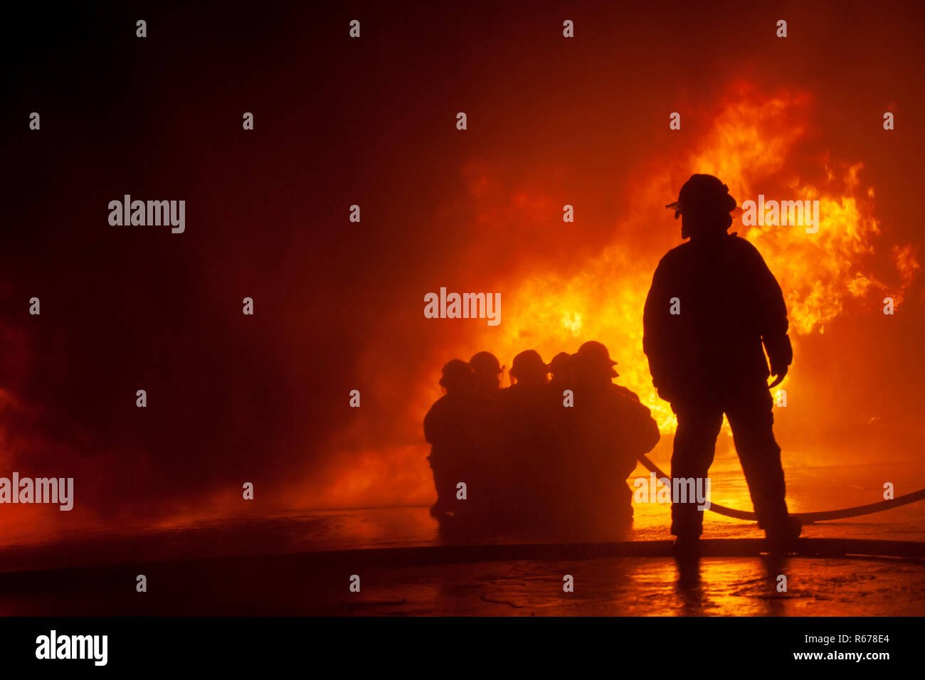 JOHANNESBURG, SOUTH AFRICA - OCTOBER, 2018 Firefighters spraying down fire during firefighting training exercise Stock Photo