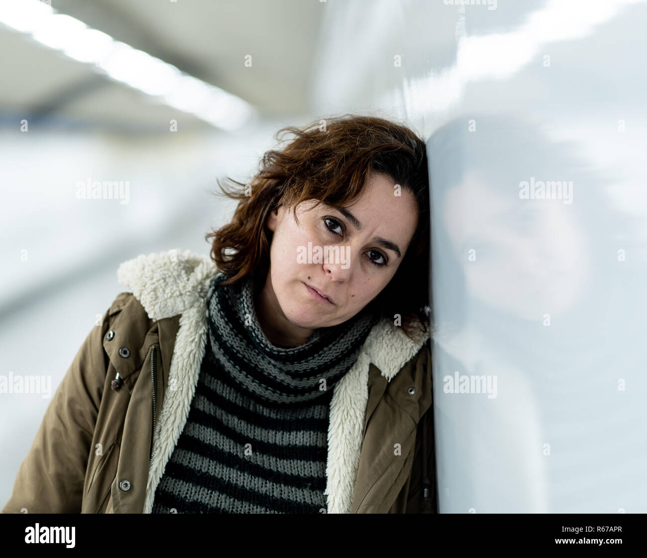 Hopeless and exhausted woman suffering depression and anxiety in subway tunnel in Work-life balance issues Negative body image Financial troubles and Stock Photo
