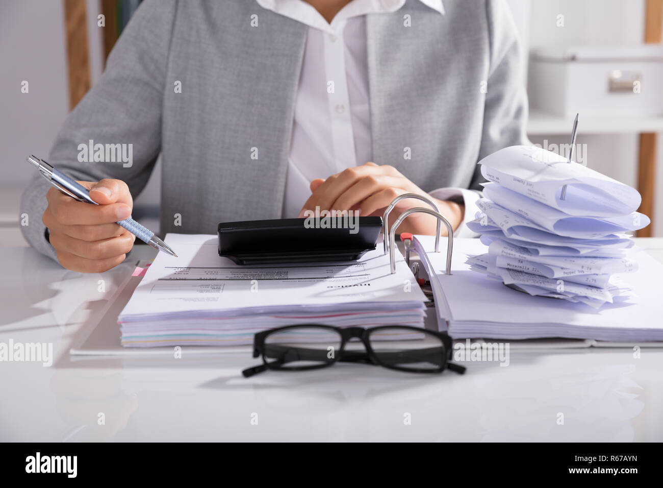 Businessperson Calculating Bills In Office Stock Photo - Alamy