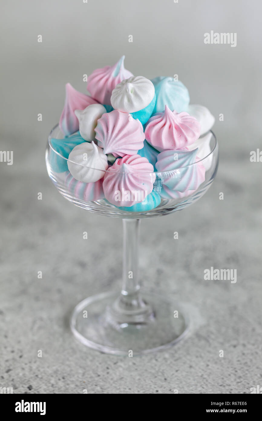 Homemade Pastel Pink Blue And White Meringue In Glass On Neutral