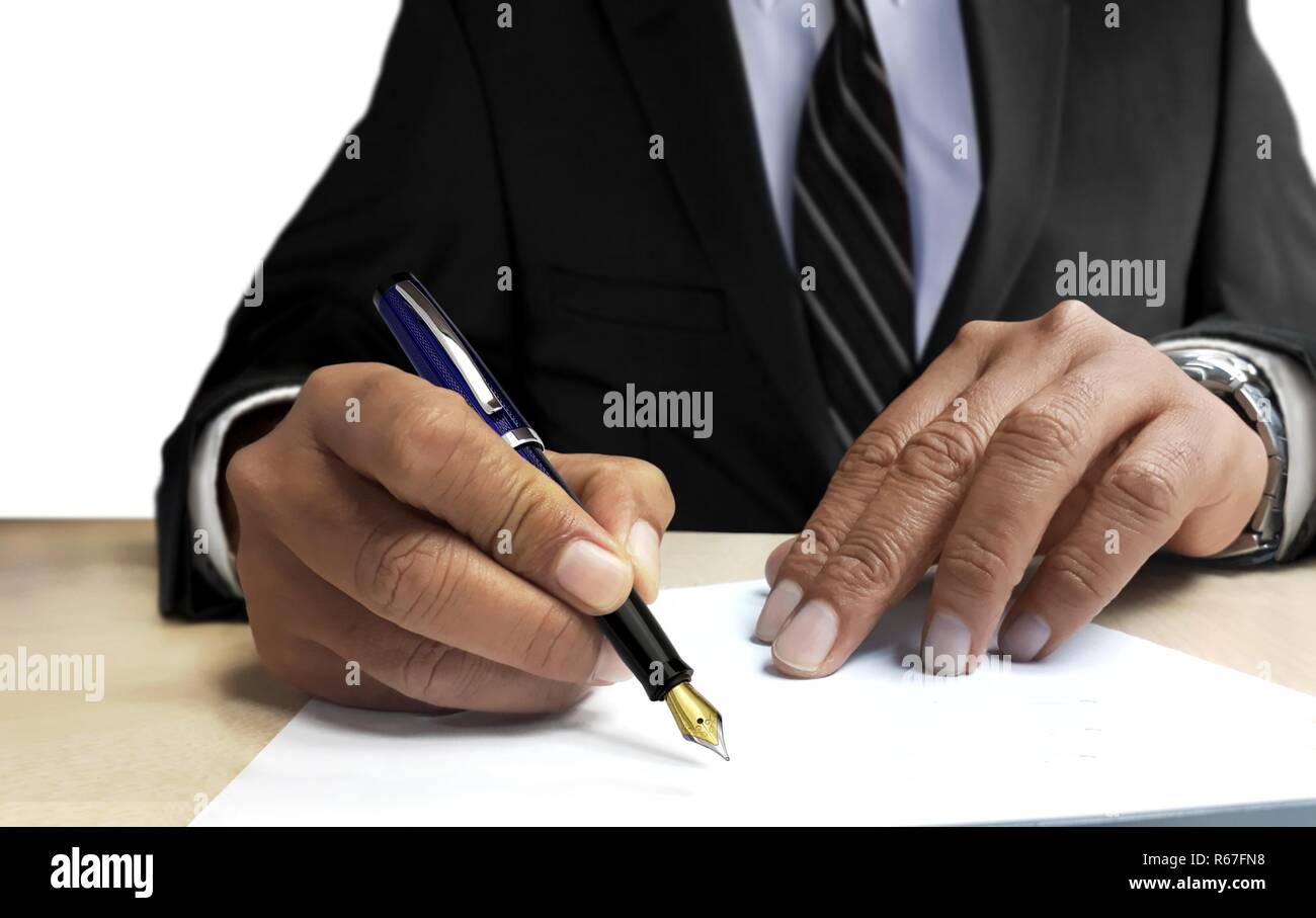 Man in suit writing on blank paper from front view angle stock photo