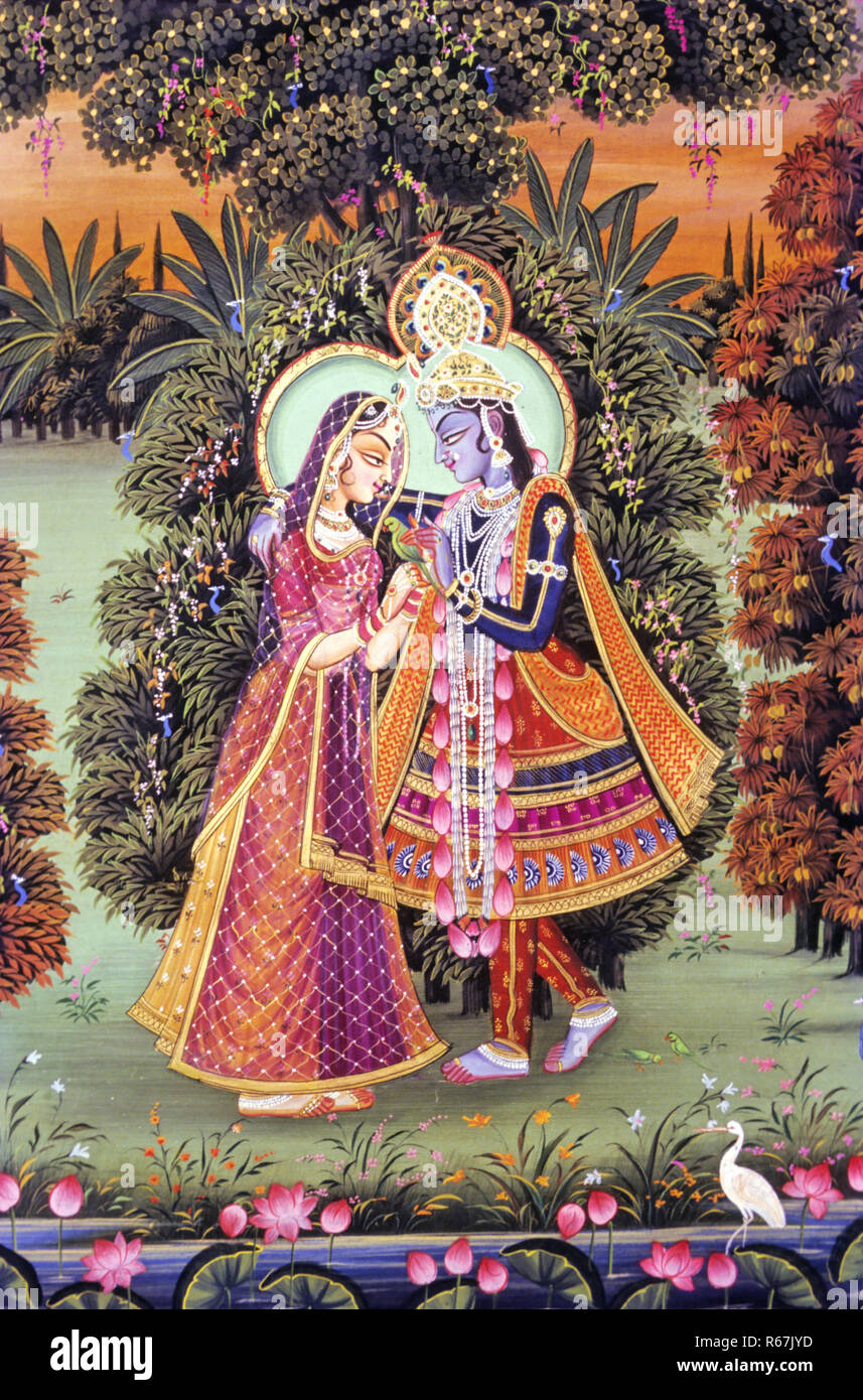 miniature painting of radha krishna in garden embracing giving flower, India Stock Photo
