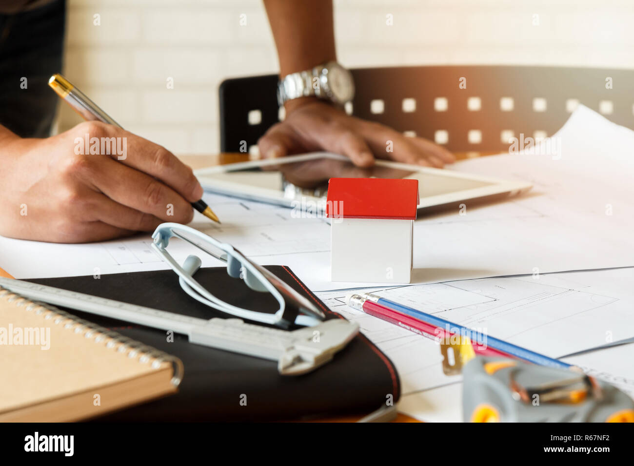Architect or engineer using pen working on blueprint, architectural concept Stock Photo