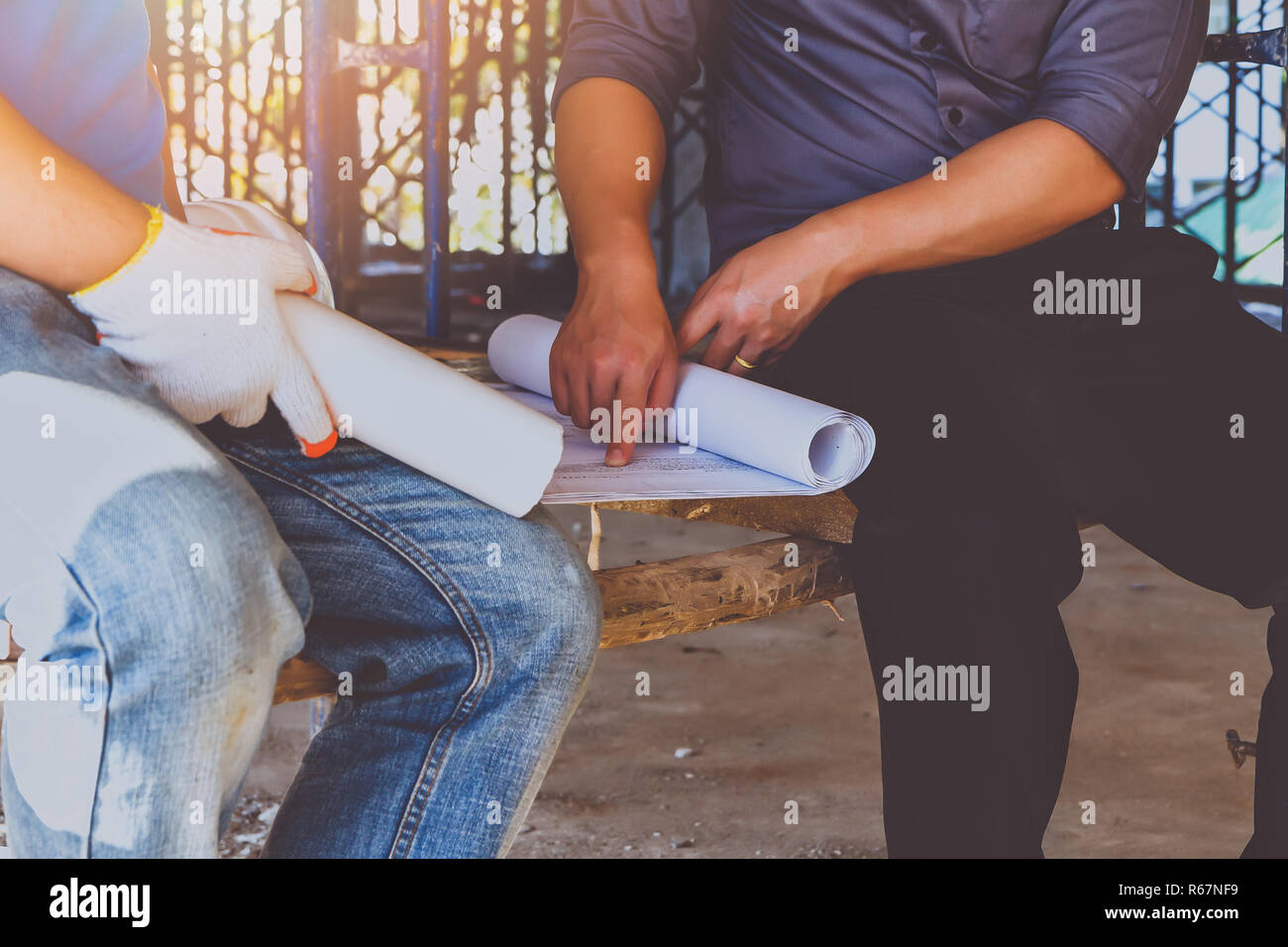 Engineer discussing with foreman about project in building construction ...
