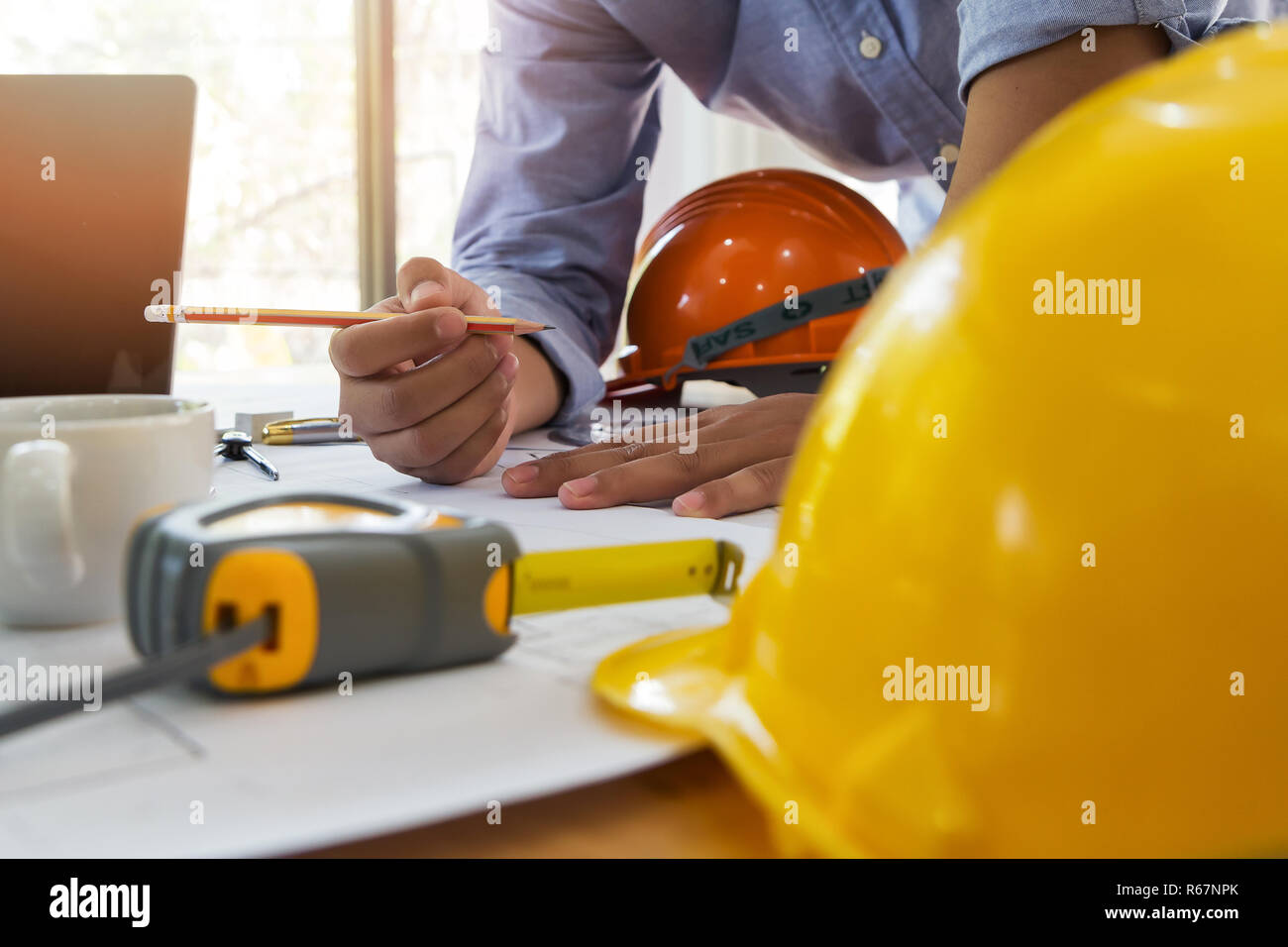 Architect or engineer working on blueprint in office, architectural concept Stock Photo