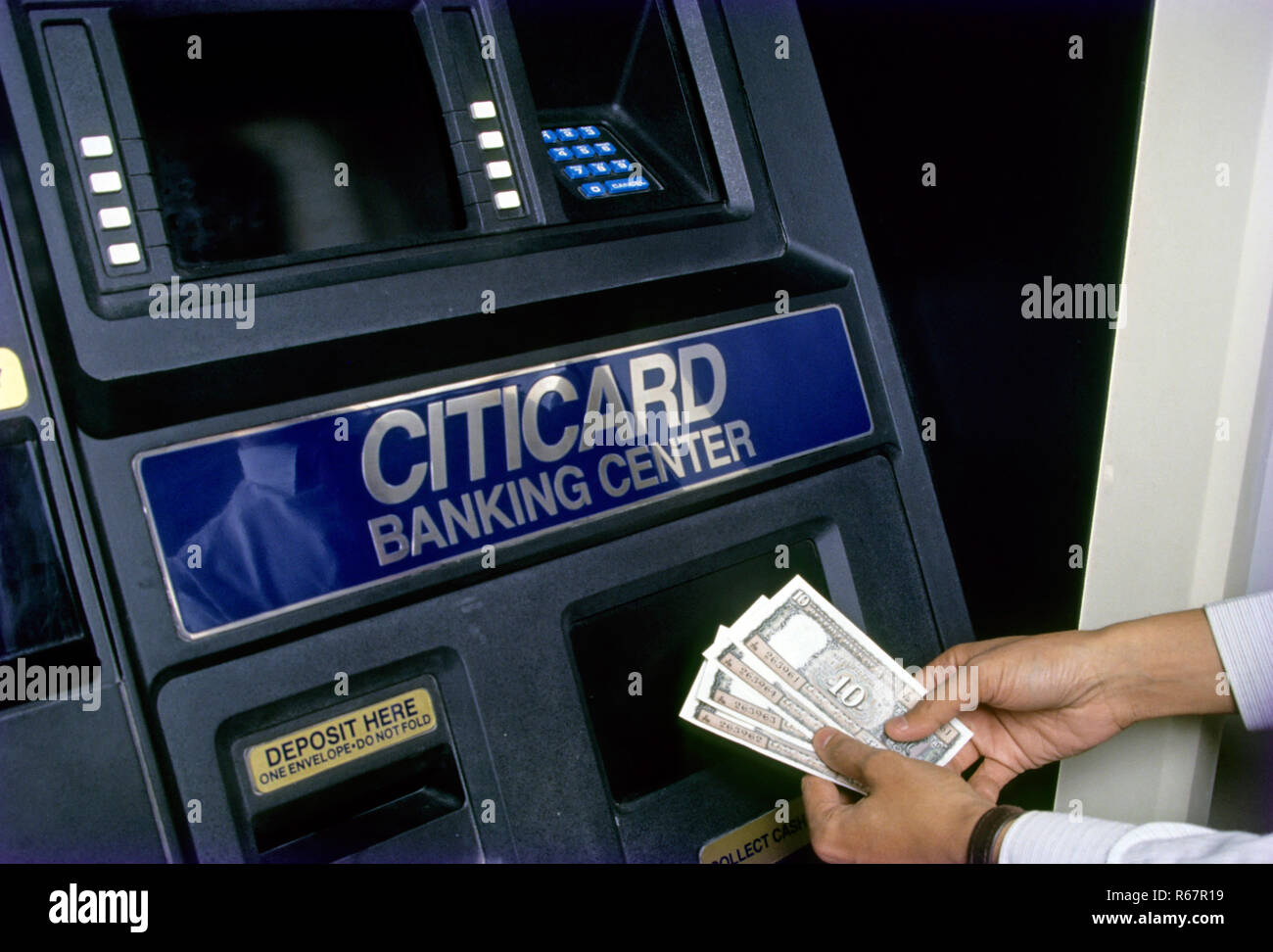 Man Men withdrawing money from Any time Money Systems (ATM) Machine ...