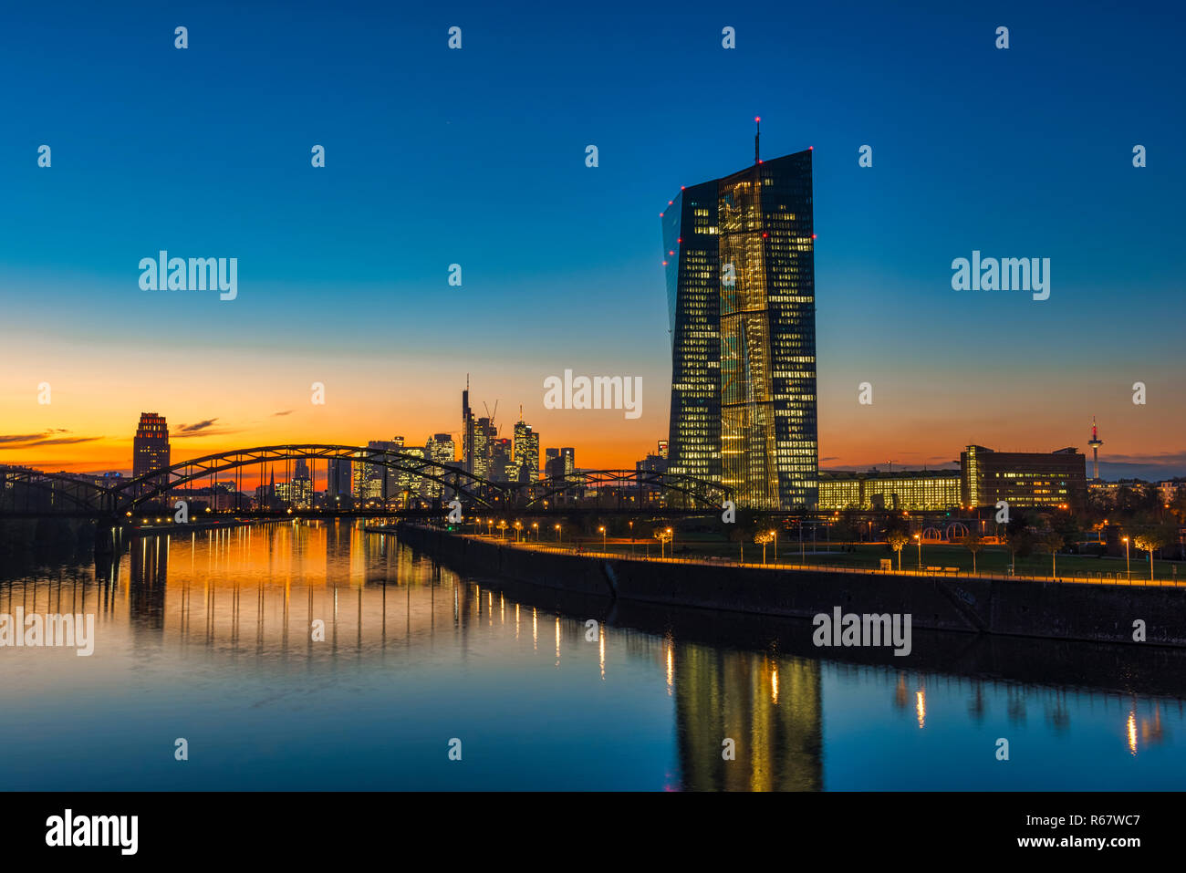 European Central Bank, ECB in front of the illuminated skyline, Osthafenbrücke, dusk, Frankfurt am Main, Hesse, Germany Stock Photo