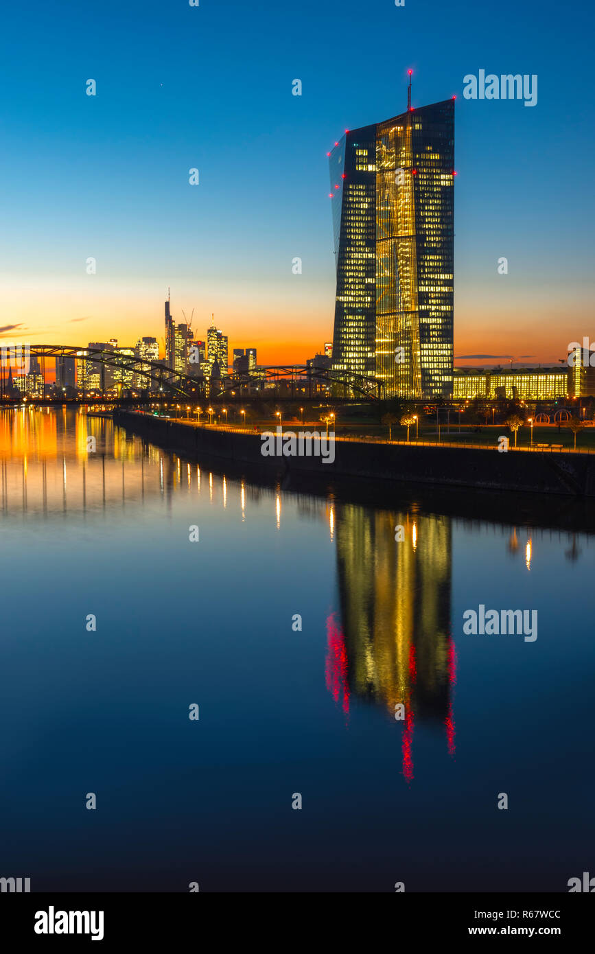 European Central Bank, ECB in front of the illuminated skyline, Osthafenbrücke, dusk, Frankfurt am Main, Hesse, Germany Stock Photo