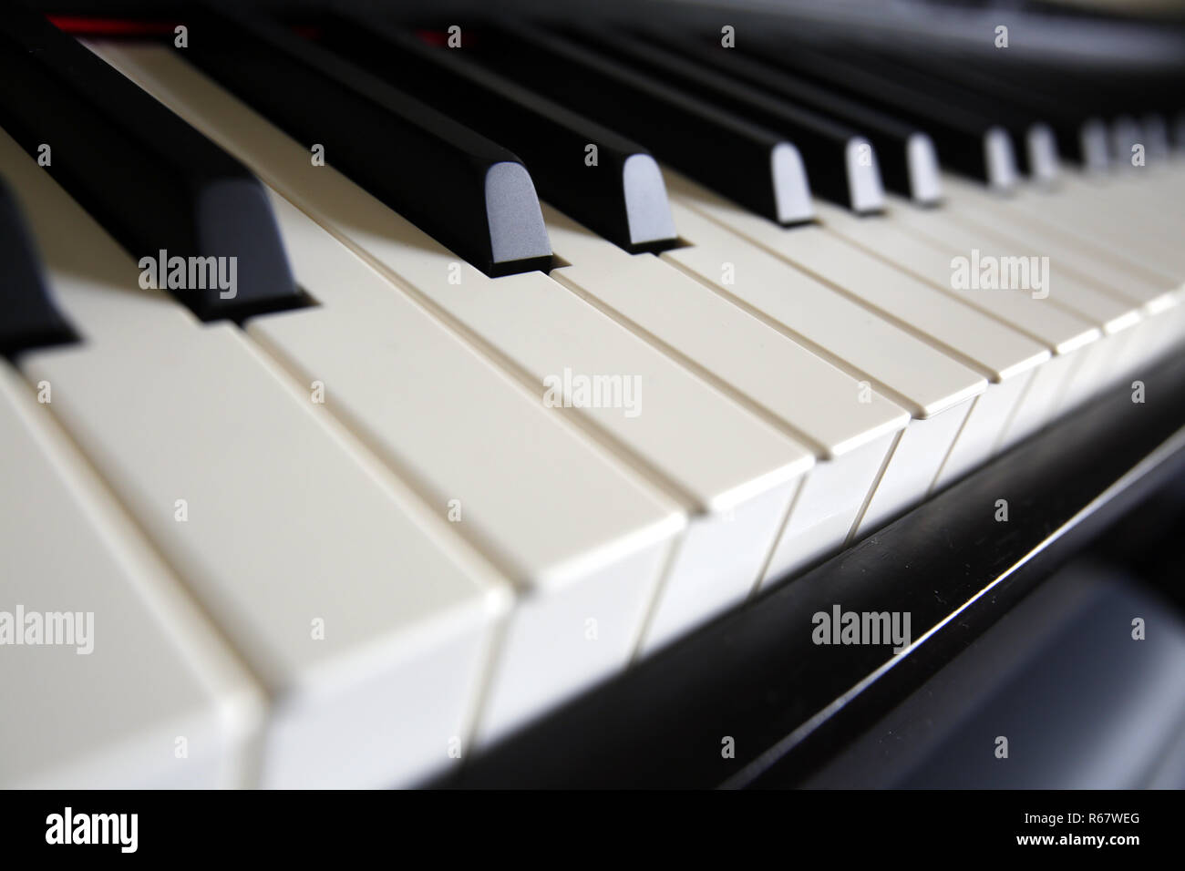 A teacher teaches playing the piano her student. Stock Photo