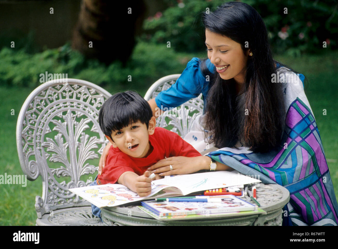 mother helping son crying during study MR.NO.162.161 Stock Photo