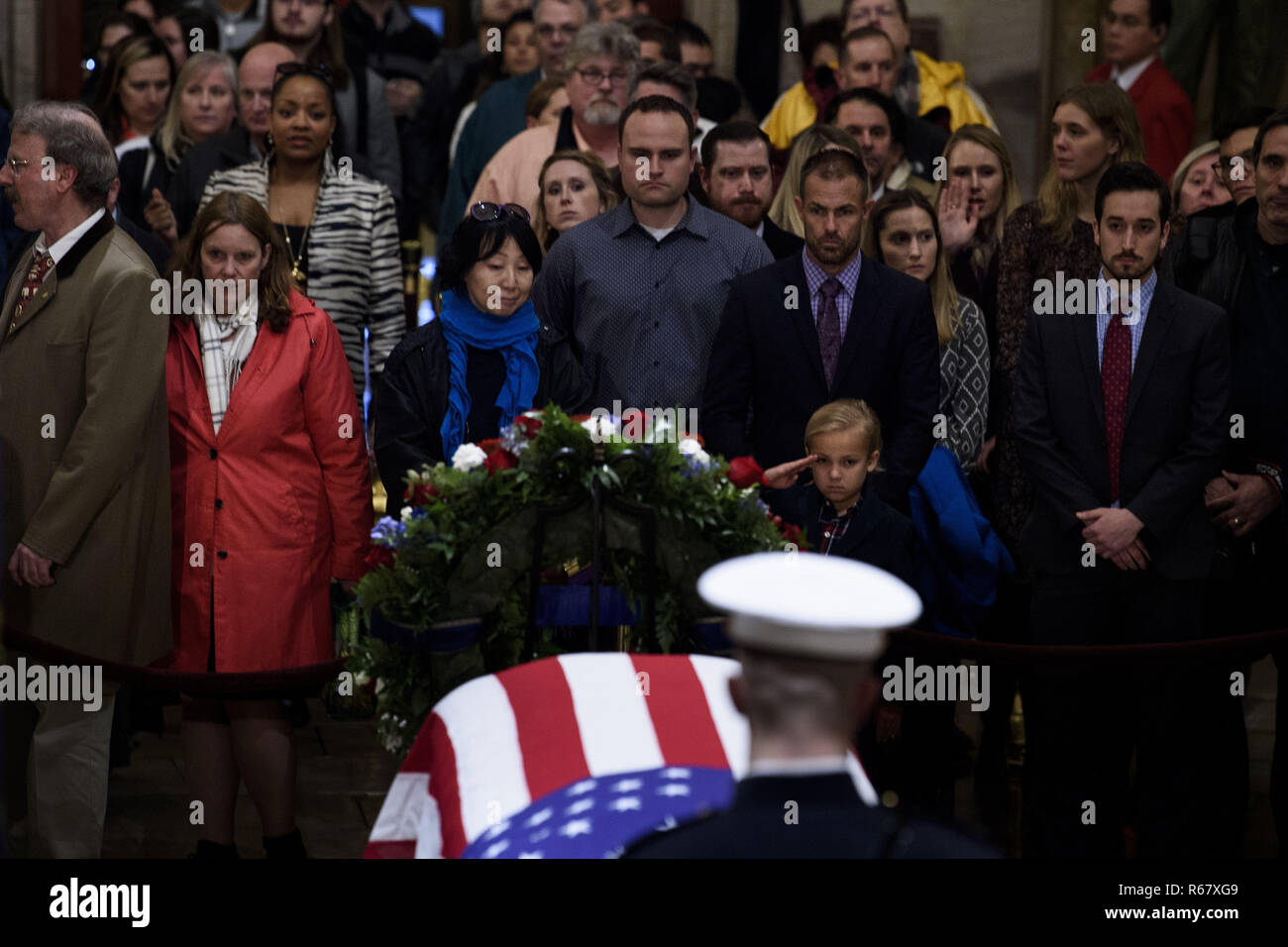 Washington, District of Columbia, USA. 3rd Dec, 2018. Stephen G. Leighton Jr. salutes while paying respects with his father Stephen G. Leighton Sr. as the remains of former US President George H. W. Bush lie in state in the US Capitol's rotunda December 3, 2018 in Washington, DC. Credit: Brendan Smialowski/CNP/ZUMA Wire/Alamy Live News Stock Photo