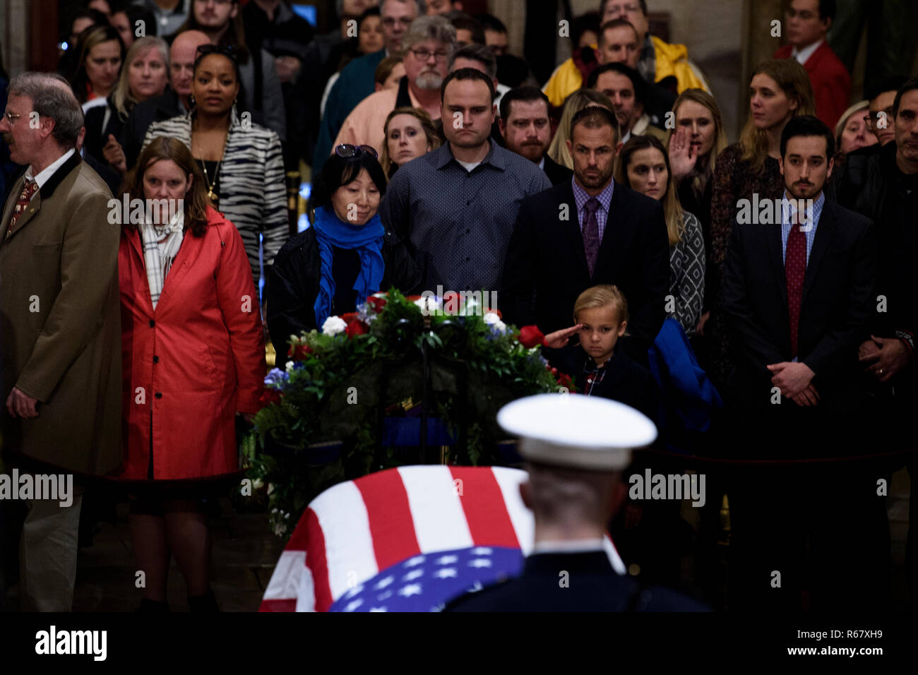 Washington, DC. 3rd Dec, 2018. Stephen G. Leighton Jr. salutes while paying respects with his father Stephen G. Leighton Sr. as the remains of former US President George H. W. Bush lie in state in the US Capitol's rotunda December 3, 2018 in Washington, DC. | usage worldwide Credit: dpa/Alamy Live News Stock Photo