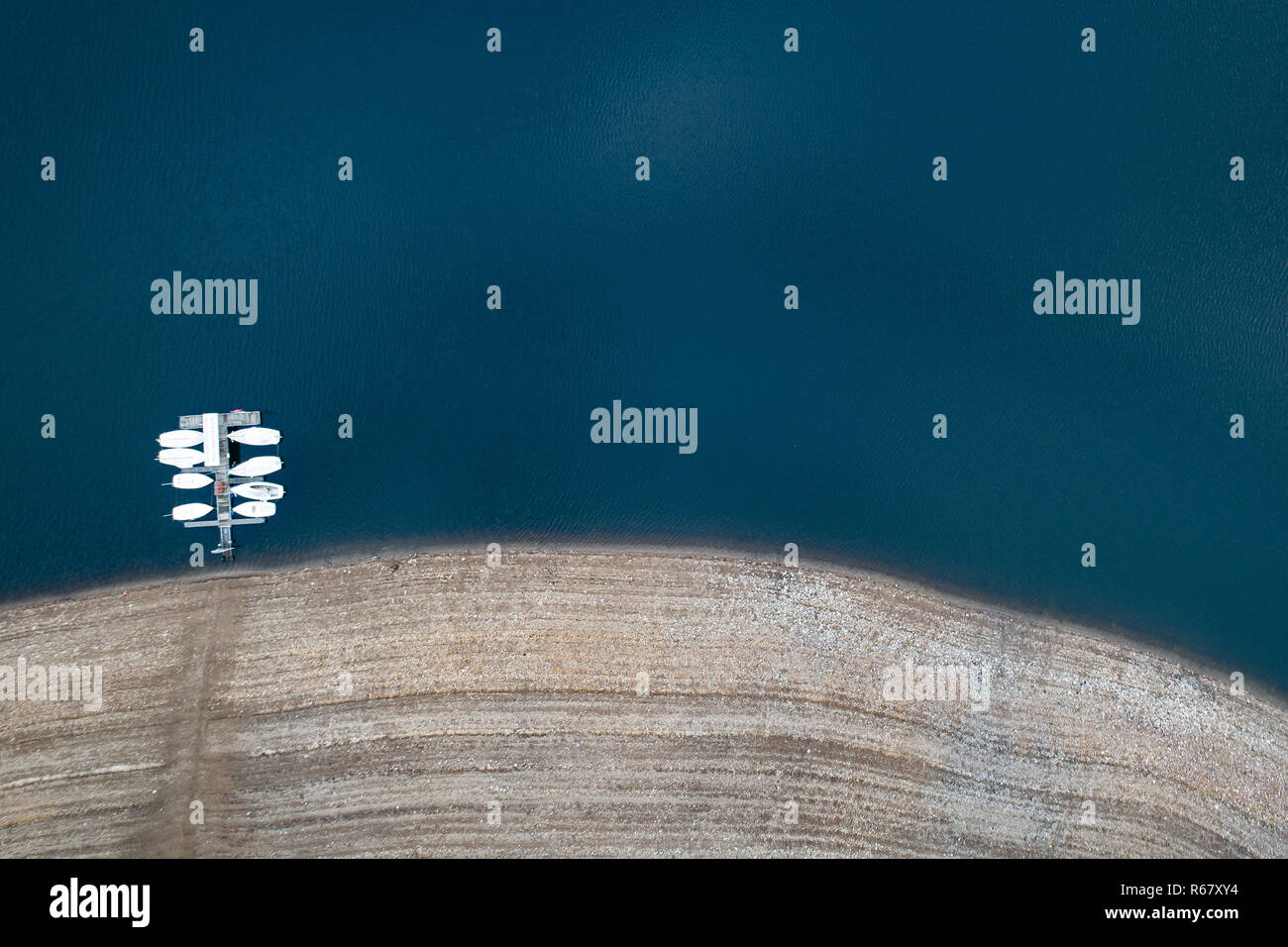 Waldeck, Germany. 03rd Dec, 2018. Boats lie at a jetty in the low tide of the Eder reservoir. The Ederstausee is the third largest reservoir in Germany in terms of volume. (Aerial photograph with drone) Credit: Swen Pförtner/dpa/Alamy Live News Stock Photo