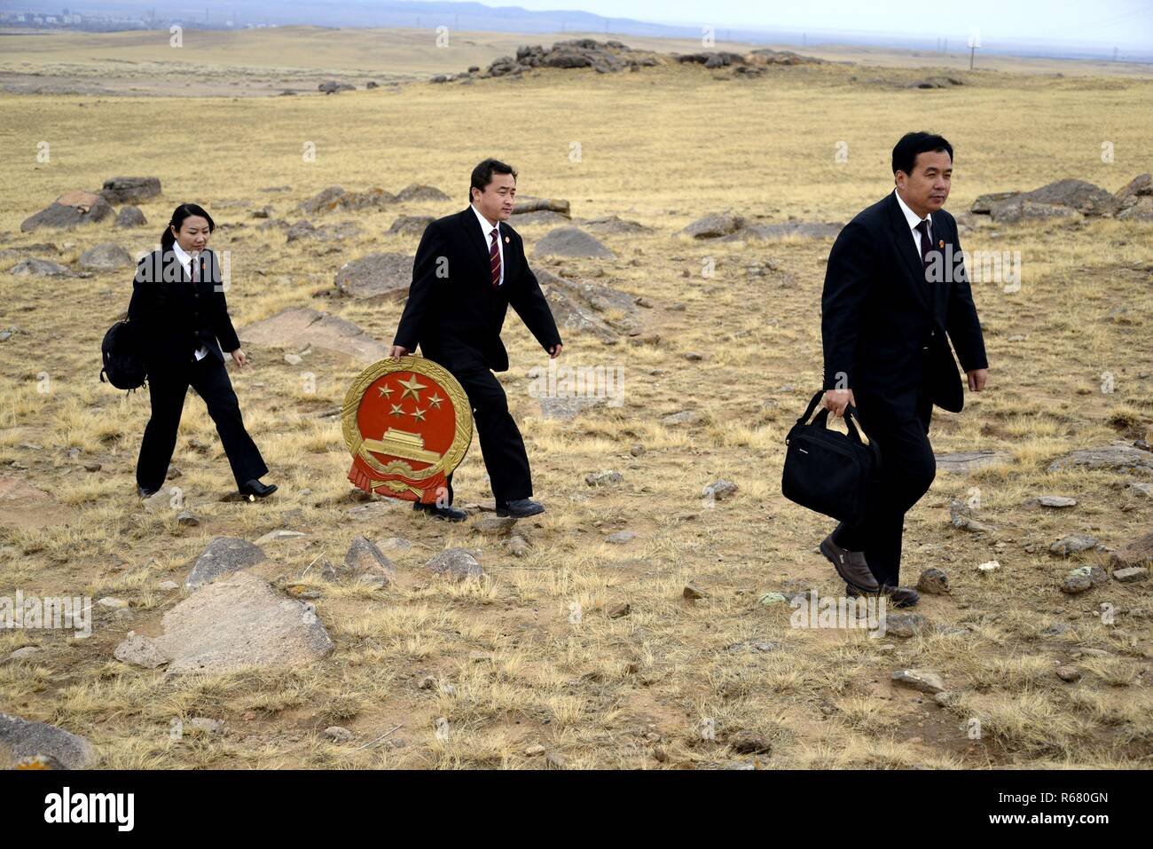 (181204) -- BEIJING, Dec. 4, 2018 (Xinhua) -- Ren Xiuyong (1st R), a judge of the assize court in Urad Middle Banner pasture, walks with colleagues to offer legal aids for local people in north China's Inner Mongolia Autonomous Region, Oct. 30, 2014. Legal aid institutions across China have handled about 6.34 million cases during the past five years, helping 6.96 million people, the Ministry of Justice said Thursday. Over the past five years, legal aid institutions at all levels have helped 2.47 million migrant workers, 328,000 people with disabilities, 585,000 elderly people and 742, 0 Stock Photo