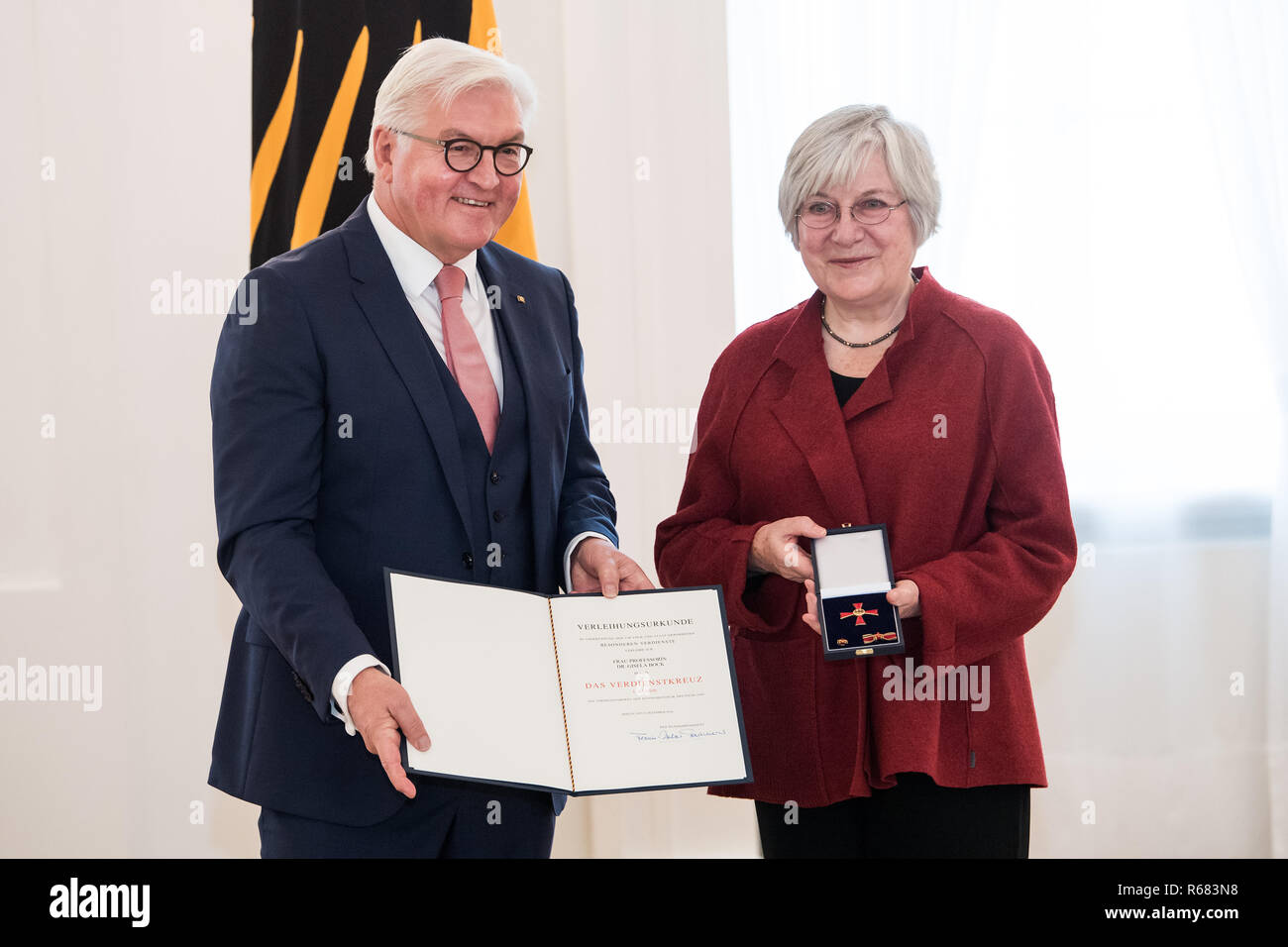 Berlin, Germany. 04th Dec, 2018. Federal President Frank-Walter Steinmeier awards the Order of Merit of the Federal Republic of Germany to Gisela Bock from Berlin. Under the motto "Future needs Remembrance", Federal President Steinmeier honoured a total of 14 women and 14 men for their outstanding commitment to the culture of remembrance and remembrance in Germany with the Order of Merit on the occasion of the honorary office day. Credit: Bernd von Jutrczenka/dpa/Alamy Live News Stock Photo