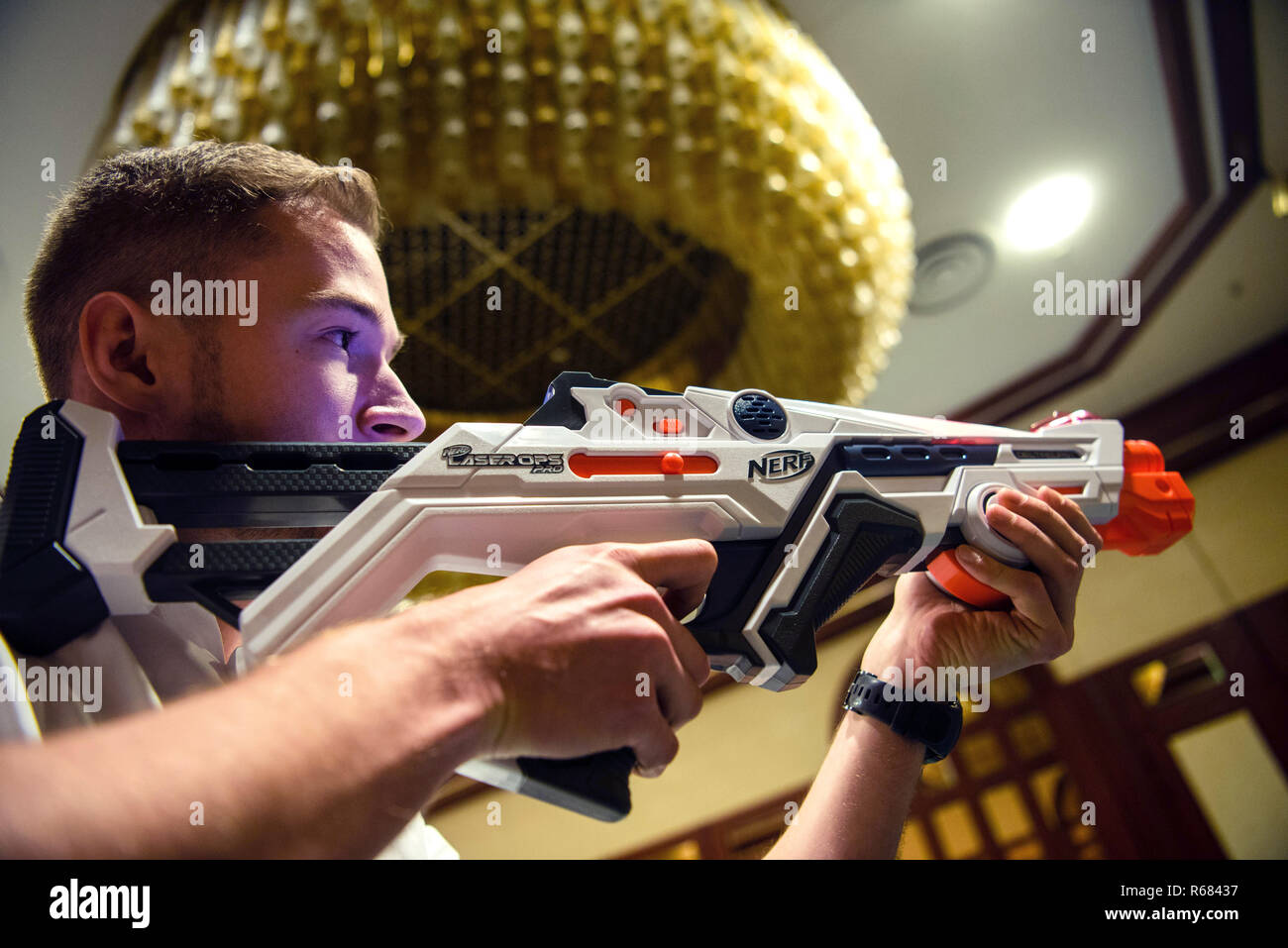 04 December 2018, Bavaria, Nürnberg: Johannes demonstrates a NERF Laser OPs  Pro Blaster from Hasbro Deutschland GmbH. The toy industry reported on  expectations and trends at a press conference. Photo: Nicolas Armer/dpa