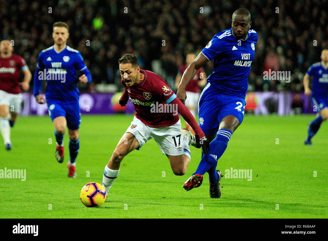 London, UK. 4th Dec 2018. Sol Bamba of Cardiff City (R) fouls Javier Hernandez of West Ham United (L). Premier League match, West Ham United v Cardiff City at the London Stadium, Queen Elizabeth Olympic Park in London on Tuesday 4th December 2018.  this image may only be used for Editorial purposes. Editorial use only, license required for commercial use. No use in betting, games or a single club/league/player publications . pic by Steffan Bowen/Andrew Orchard sports photography/Alamy Live news Stock Photo