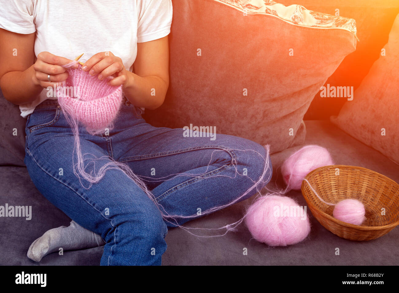 Close-up of woman hands knitting colorful  pink wool yarn. Close-up knitting photo. Freelance creative working and living concept Stock Photo