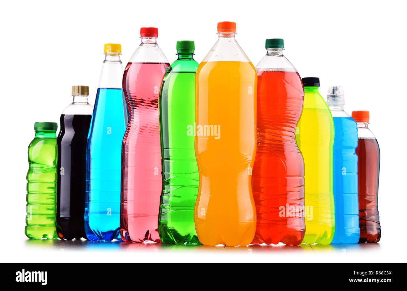 Plastic bottles of assorted carbonated soft drinks over white Stock