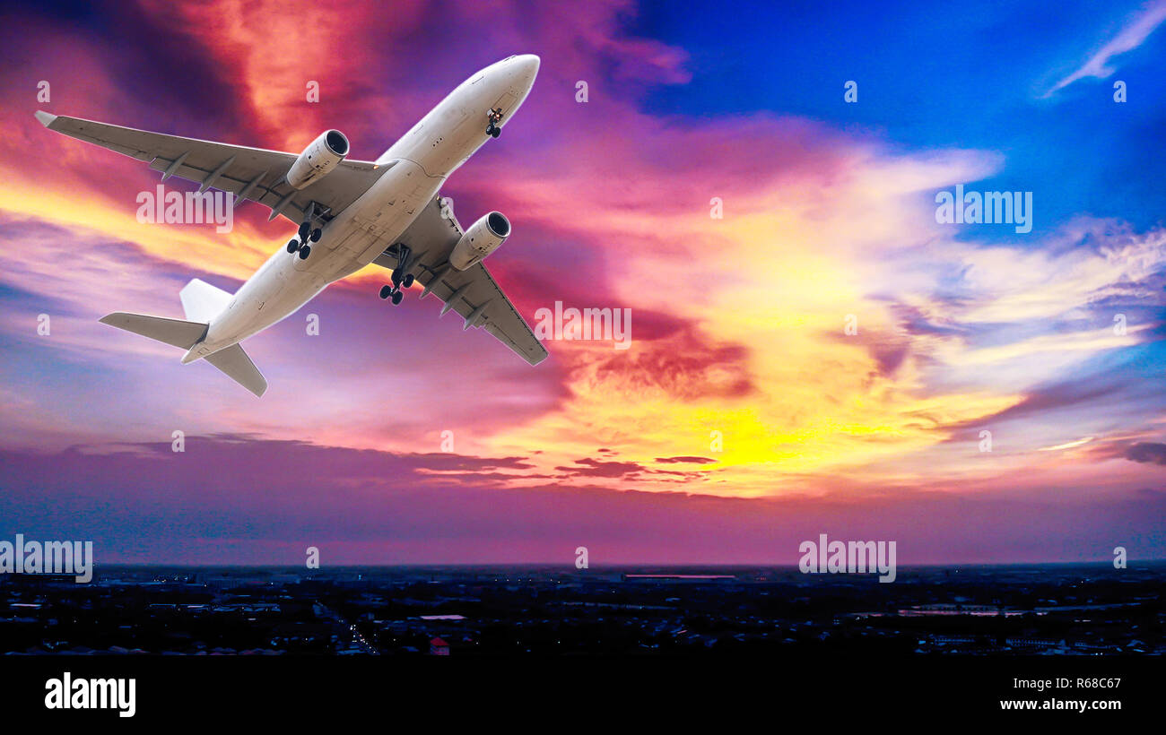 Airplane in the sunset sky flight travel transport airline background concept. Stock Photo