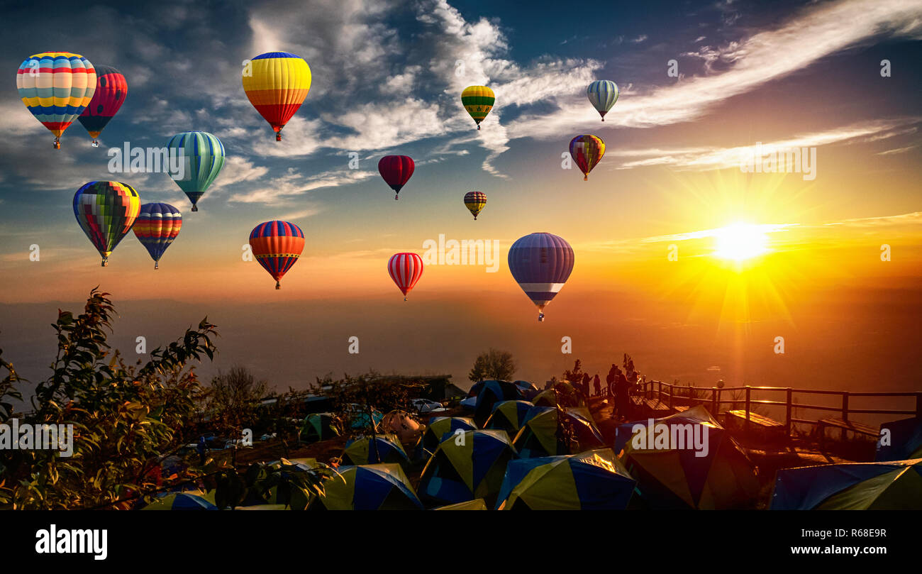 Dramatic panorama of mountain with hot air balloons at sunset,Thailand. Stock Photo