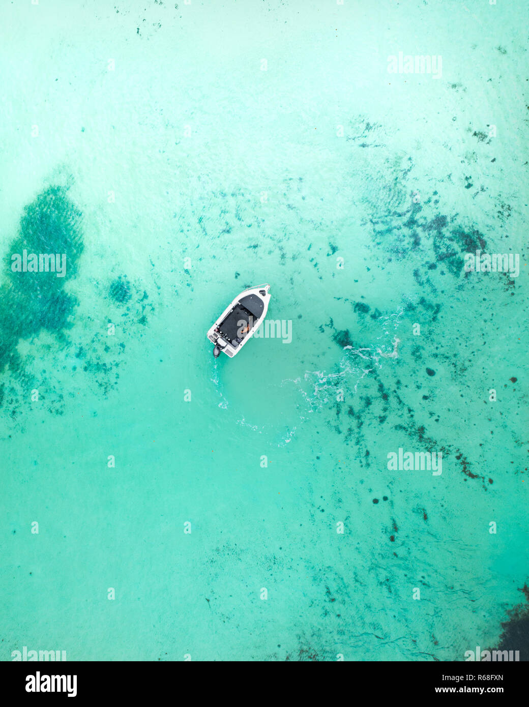 Aerial view of a boat in blue turquoise water Stock Photo - Alamy