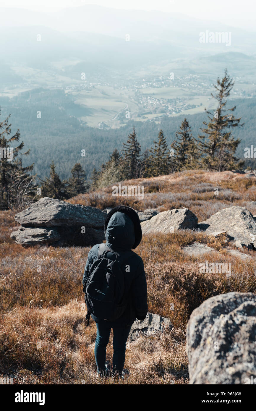 Unrecognizable woman is hiking in the upper bavarian forest in the near of the Osser, germany. Color graded. Stock Photo