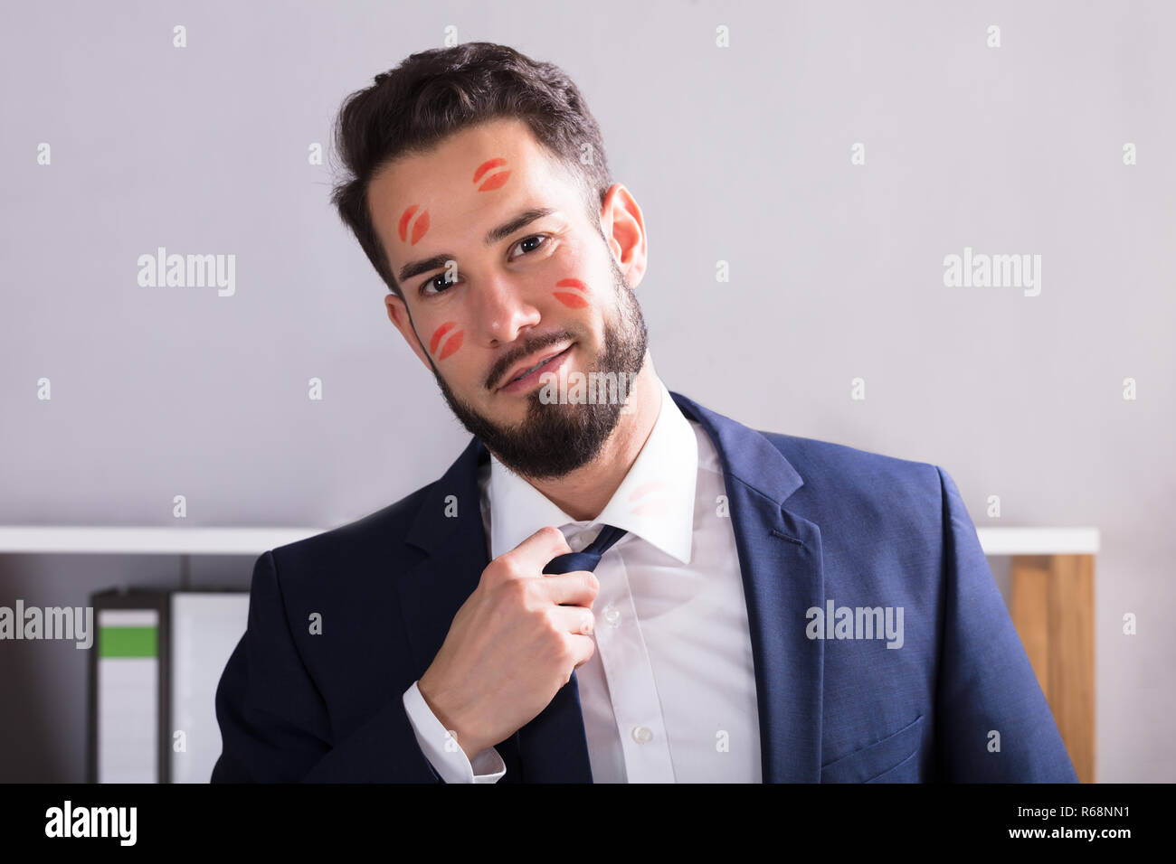 Businessman With Lipstick Kiss Marks On Face Stock Photo Alamy