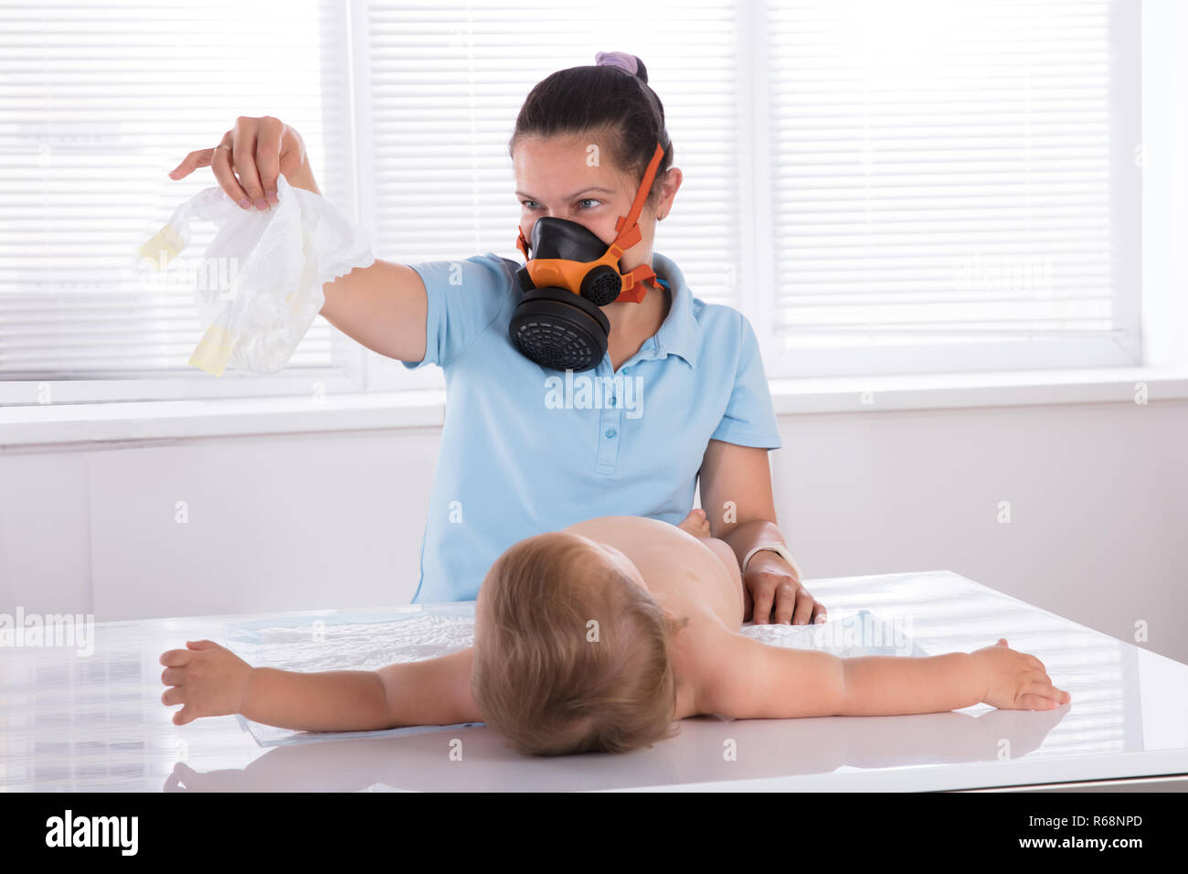 Woman Changing Smelly Nappy Of Her Baby Stock Photo - Alamy