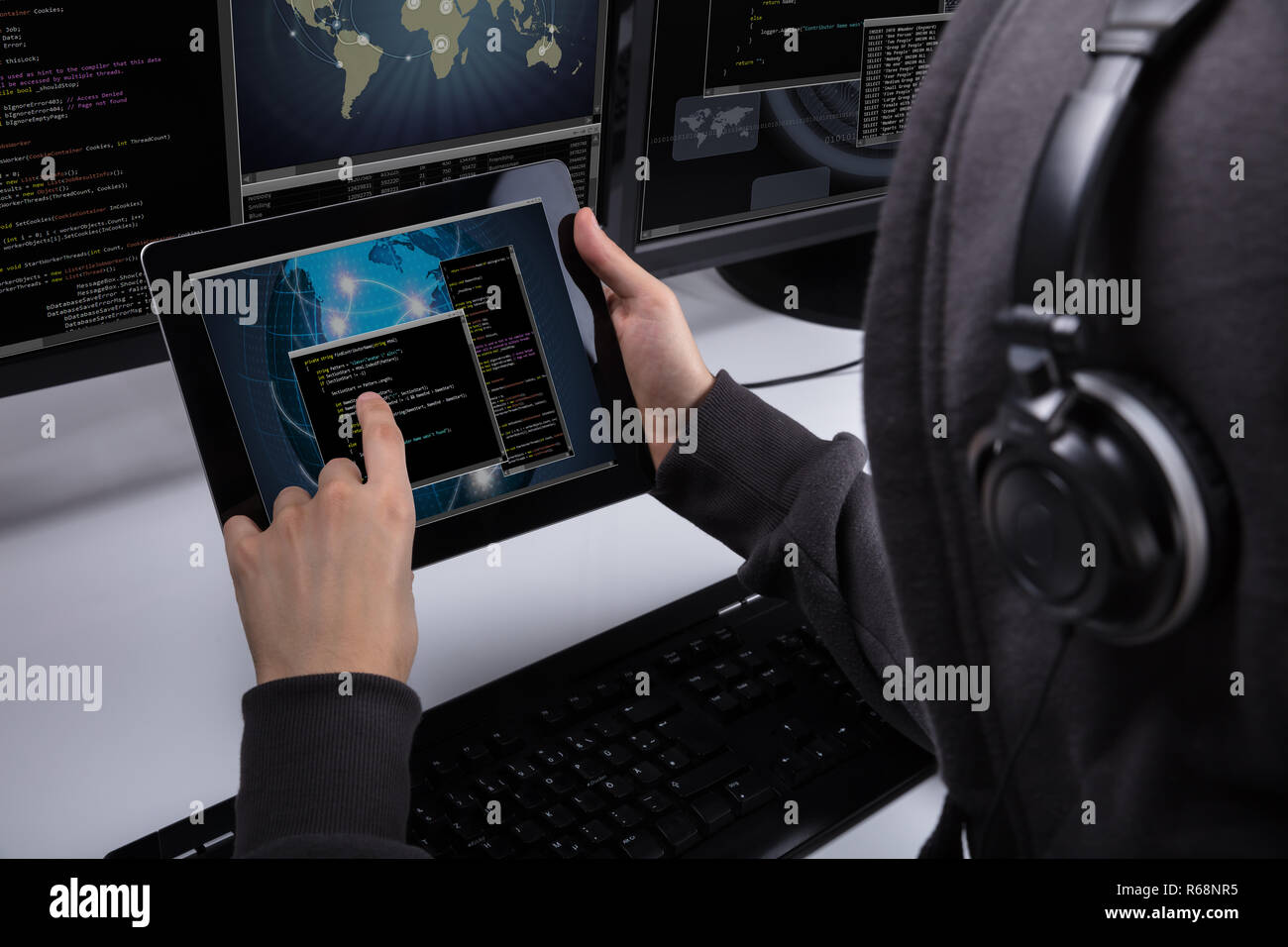 Hacker Using Digital Tablet For Stealing Data Stock Photo