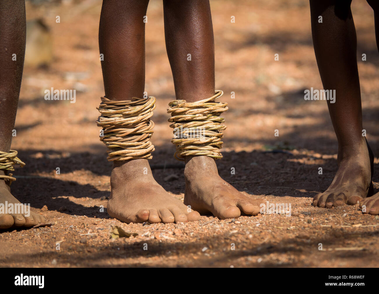 Himba tribe feets with traditional bracelets, Cunene Province, Oncocua, Angola Stock Photo