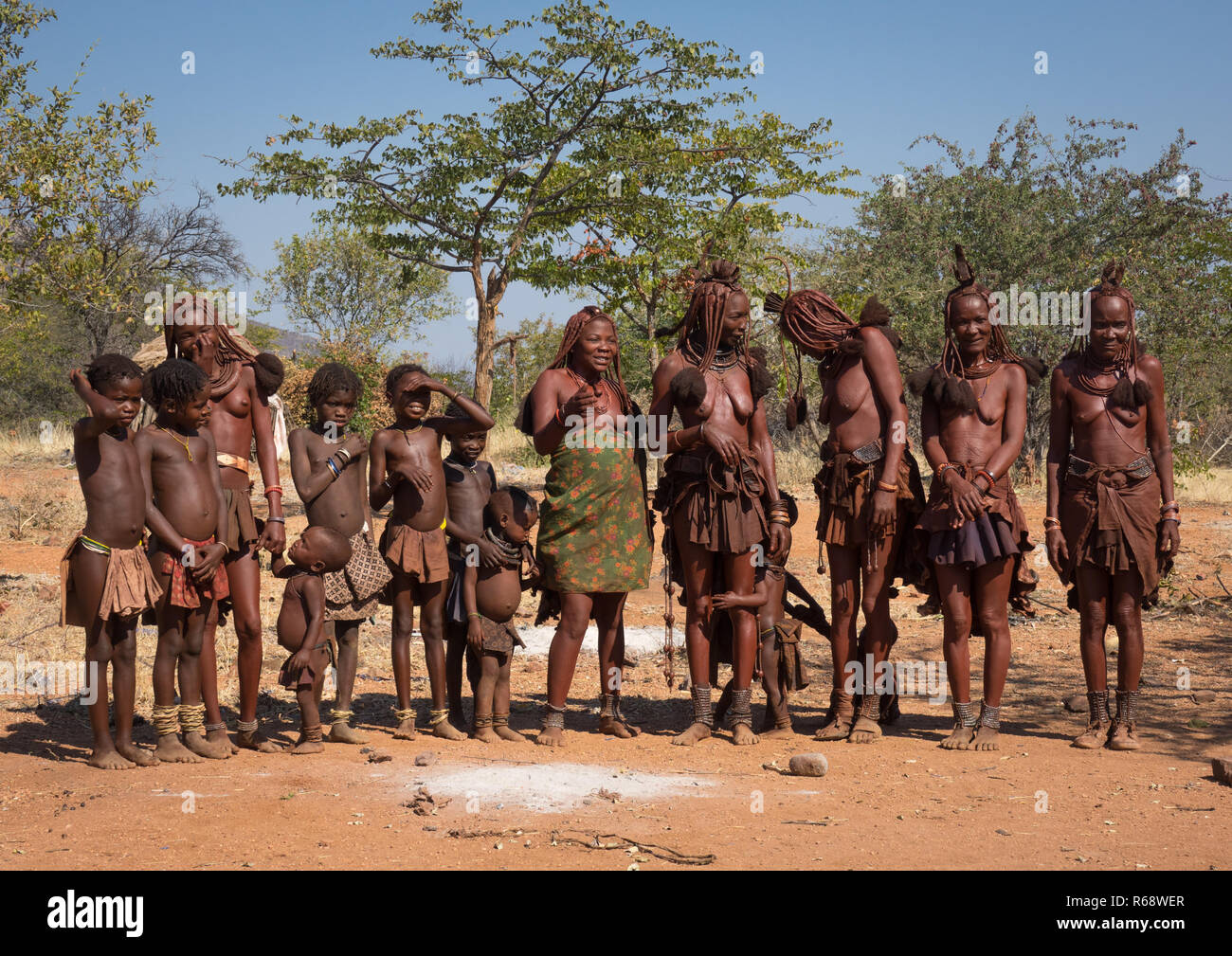 Himba tribe relatives in their village, Cunene Province, Oncocua, Angola Stock Photo