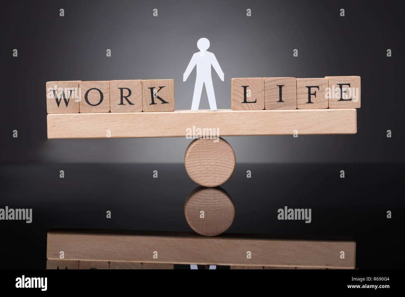 Human Figure Balancing Between Work And Life On Seesaw Stock Photo - Alamy