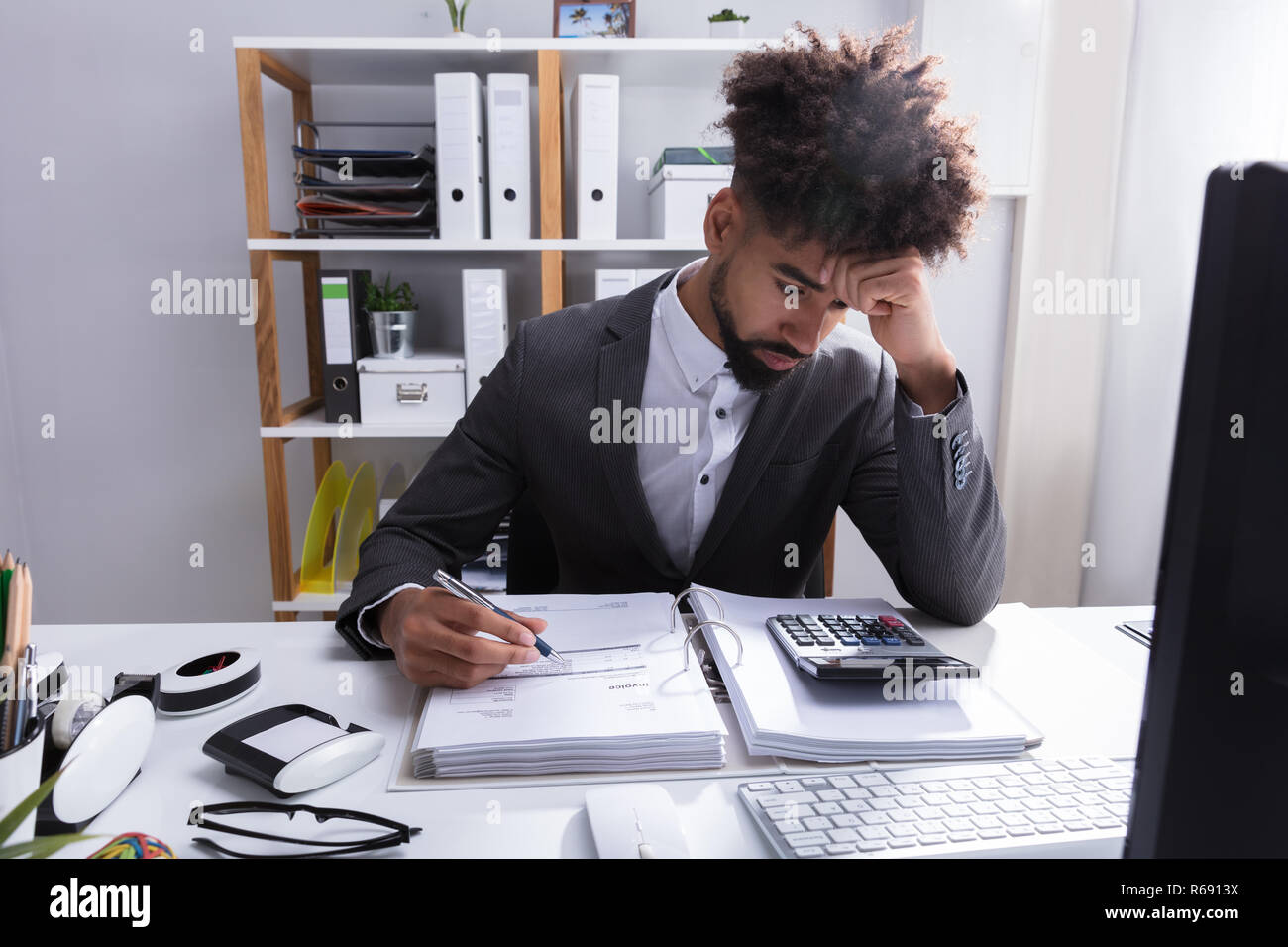 Unhappy Businessman Working In Office Stock Photo